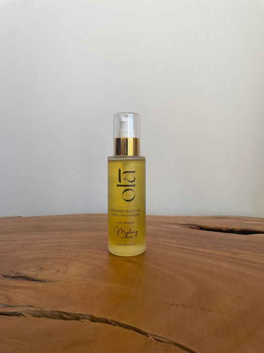 Scented Body Oil with argan oil - Mystery - 100ml Matte Glass Bottle with Pump: Treat yourself to our luxurious argan body oil, delicately scented and Crafted with a peach notes and summer aromas, housed in a 100ml matte glass bottle with a convenient pump dispenser. Enriched with the goodness of argan oil, this body oil deeply moisturizes and nourishes your skin, leaving it soft, smooth, and delicately perfumed.